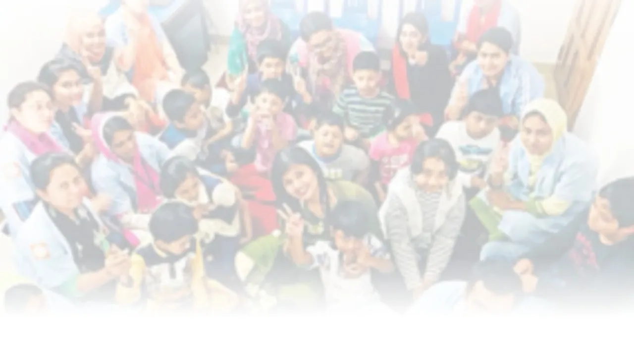 Children and carers together, smiling at the camera